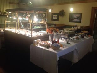 there is a buffet table with a lot of food on it .