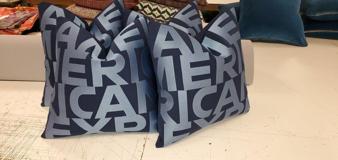A blue pillow with the word america on it