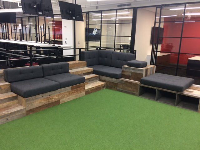 A living room with a lot of furniture and a green carpet