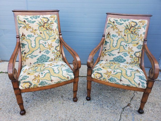 A pair of chairs with a dragon pattern on them