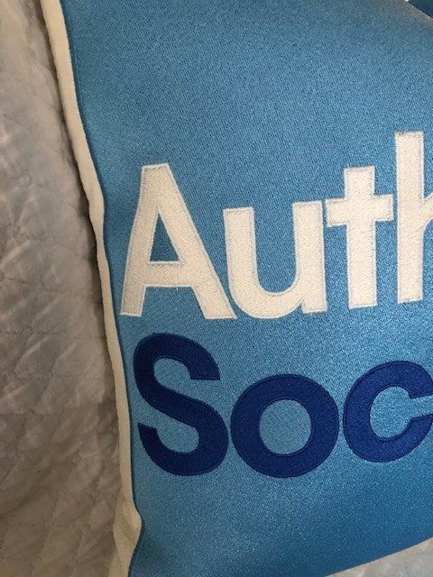 A blue pillow that says auth soc on it