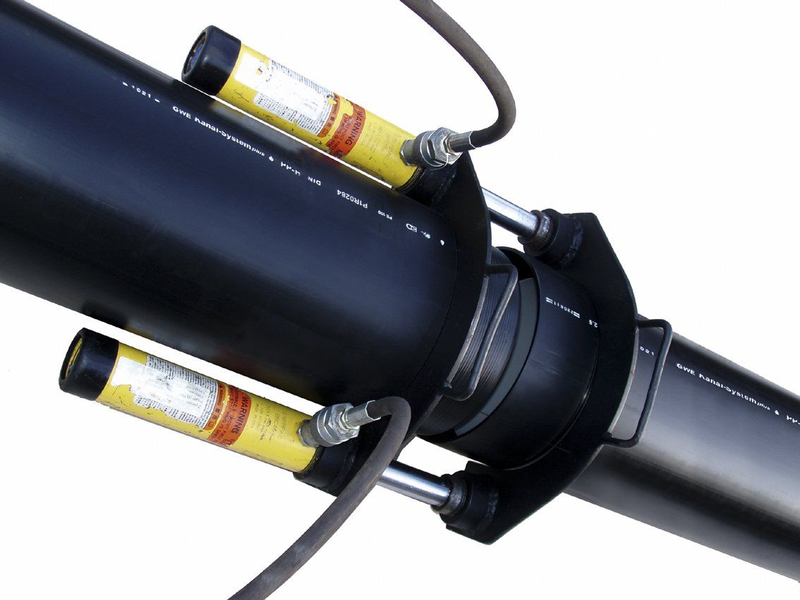 A black pipe with two yellow tubes attached to it