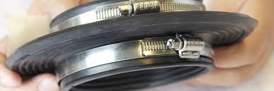 A close up of a person holding a hose clamp.