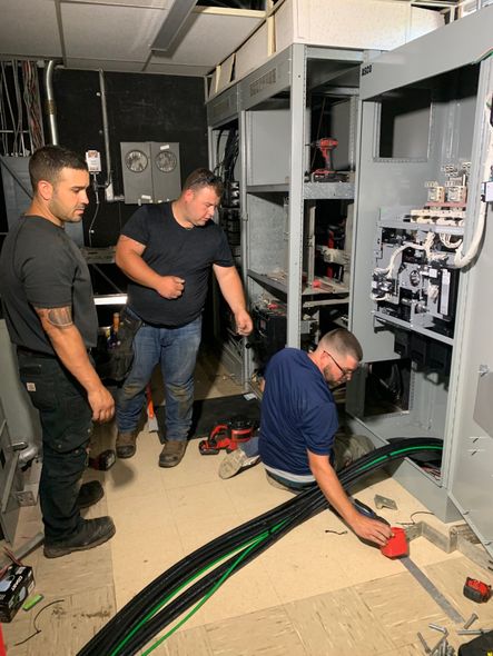 Electrician Checking A Fuse Box - licensed electrician in North Andover, MA Electrician Checking A Fuse Box - licensed electrician in North Andover, MA