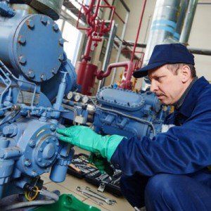 Repair — Worker at Industrial Compressor Station in Tulare, CA Repair — Worker at Industrial Compressor Station in Tulare, CA