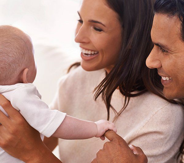 Happy Couple with a Baby — Hanover, PA — Strausbaugh Law PLLC Happy Couple with a Baby — Hanover, PA — Strausbaugh Law PLLC