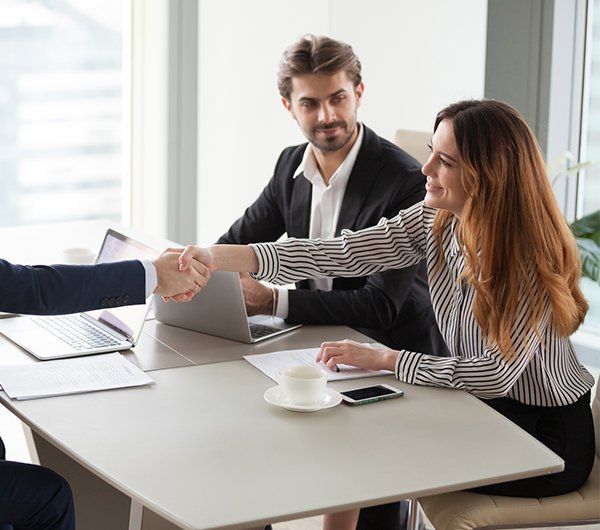 Businessman Handshaking Businesswoman — Hanover, PA — Strausbaugh Law PLLC Businessman Handshaking Businesswoman — Hanover, PA — Strausbaugh Law PLLC