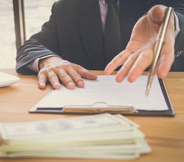 Business Man Signing a Contract — Hanover, PA — Strausbaugh Law PLLC Business Man Signing a Contract — Hanover, PA — Strausbaugh Law PLLC