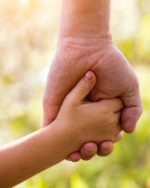 Holding Hand with a Father and Child — Hanover, PA — Strausbaugh Law PLLC Holding Hand with a Father and Child — Hanover, PA — Strausbaugh Law PLLC
