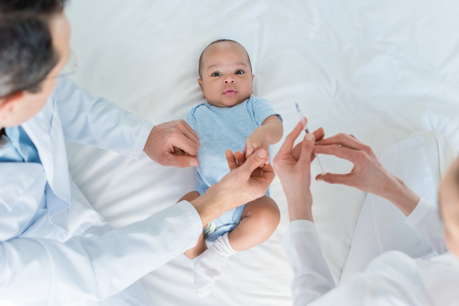Pediatric Doctors working with baby