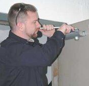 Employee Fixing Door Hinge, Herndon, VA, Spencer's Safe & Lock Employee Fixing Door Hinge, Herndon, VA, Spencer's Safe & Lock