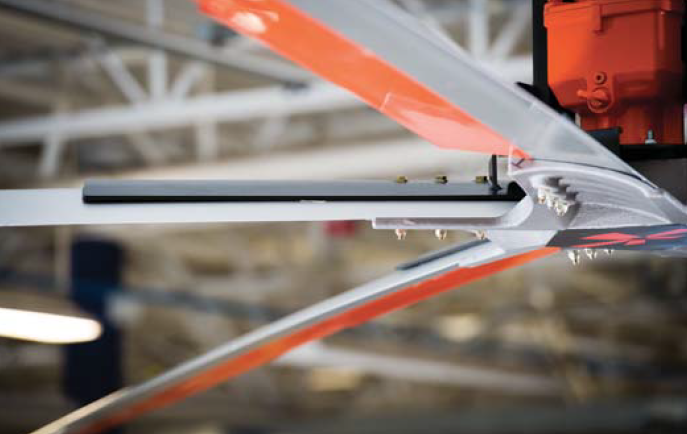 A close up of a helicopter propeller in a factory.