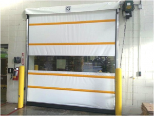 A white door with yellow stripes is in a warehouse
