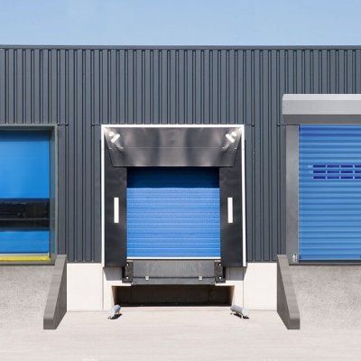 A warehouse with blue doors and a loading dock