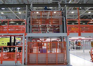 A large warehouse with a lot of machinery and stairs.