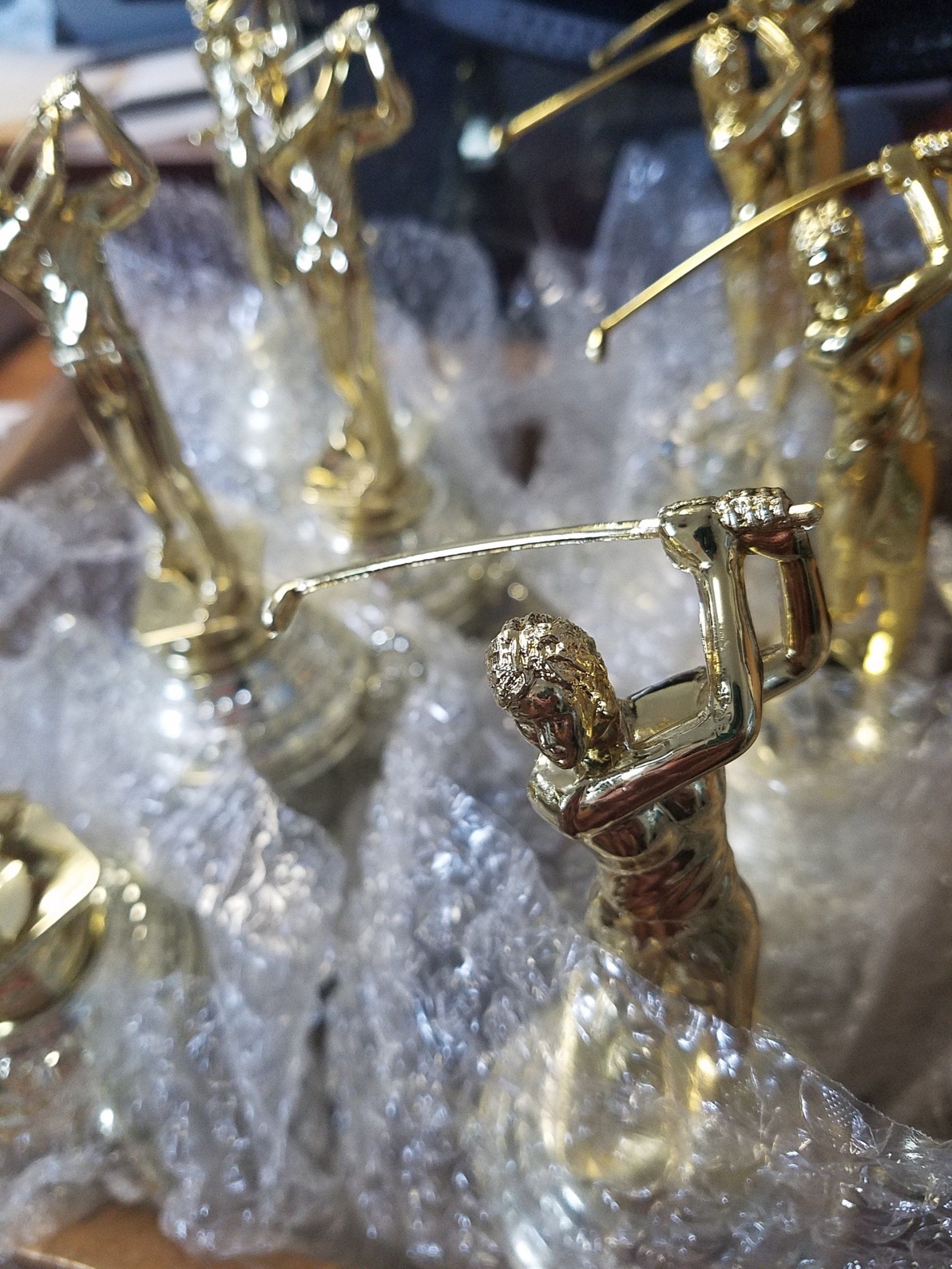 A bunch of gold statues are sitting on a table