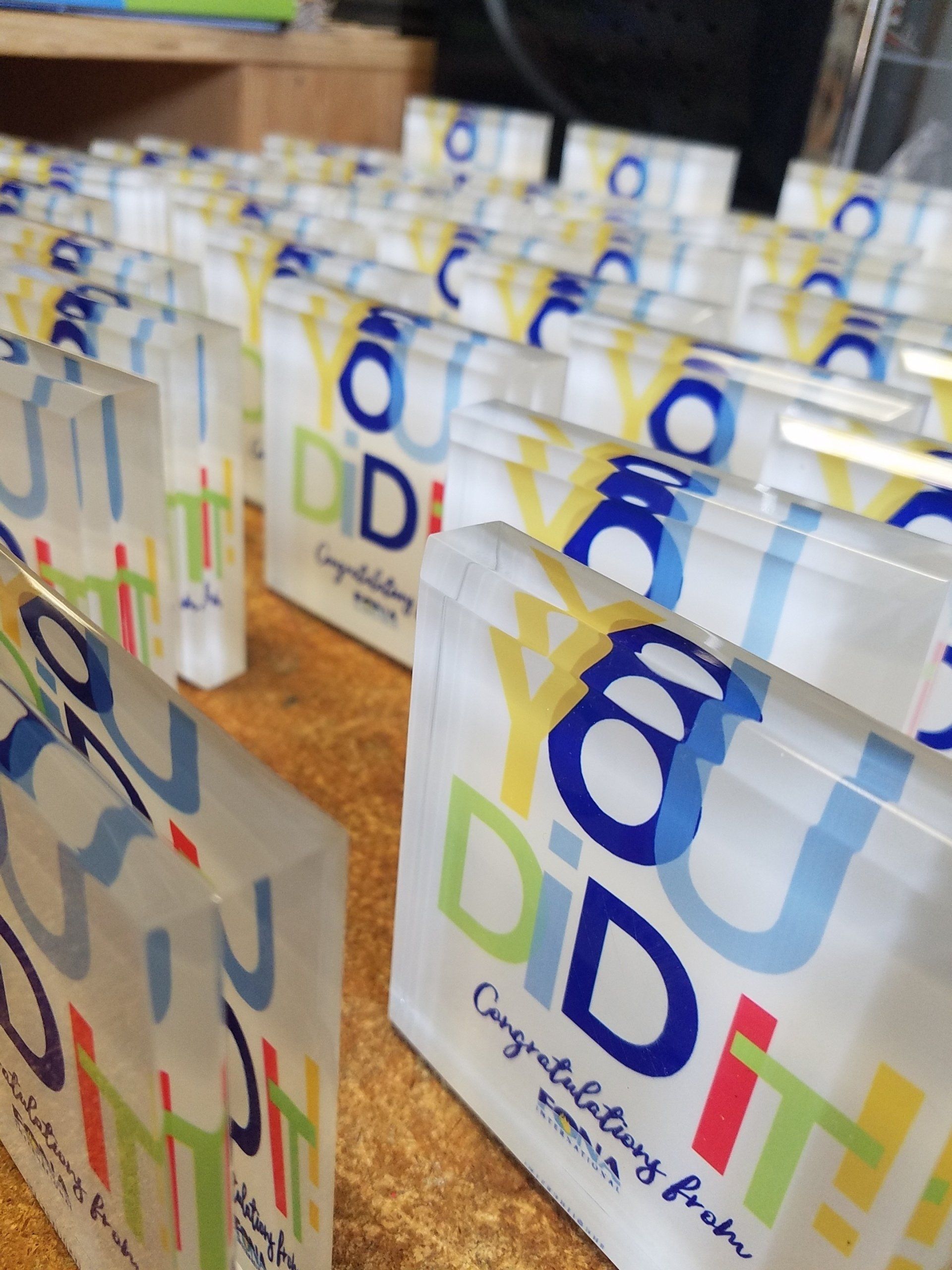 A bunch of acrylic plaques that say you did