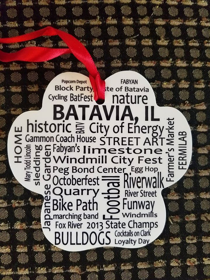 A batavia il christmas ornament with a red ribbon