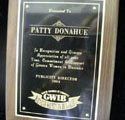 A plaque for patty donahue is sitting on a table.