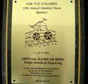 A gold plaque with a picture of a car on it.