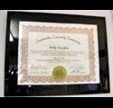 A framed certificate is hanging on a wall.