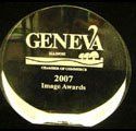 A round glass trophy with the word geneva on it.