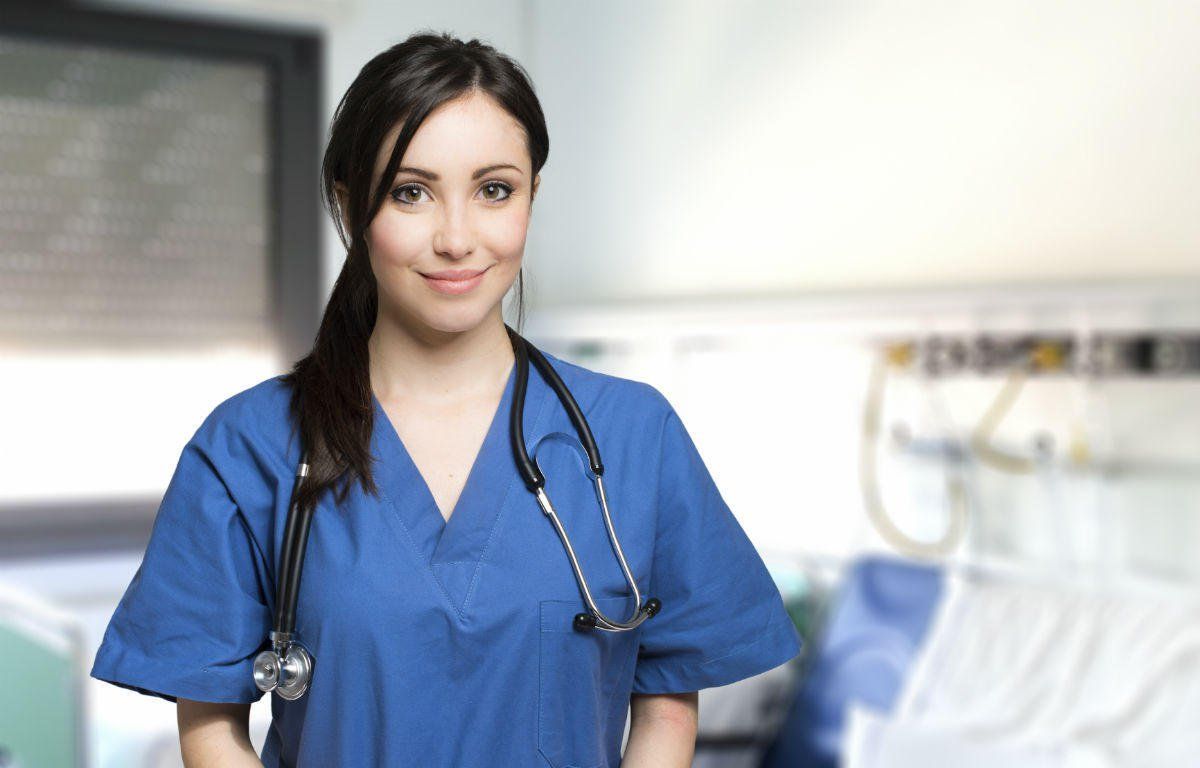 Smiling nurse wearing blue scrubs
