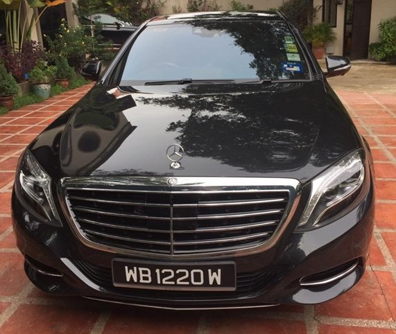 Black Mercedes-Benz sedan parked on a brick patio. License plate reads WB 1220 W.