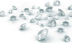 A bunch of diamonds are floating in the air on a white surface.