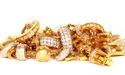 A pile of gold jewelry with diamonds on a white background.