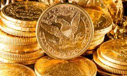 A pile of gold coins with a gold coin in the middle.