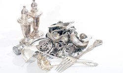 A pile of silverware is sitting on top of a table.