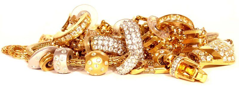 A pile of gold jewelry on a white background.