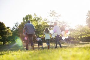 Happy family walking at the park on a sunny day