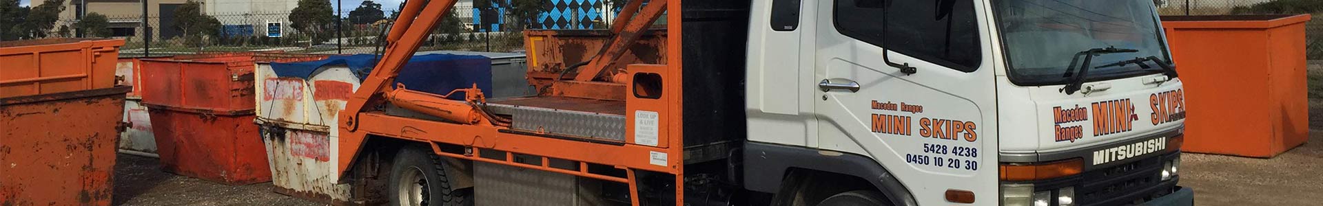 Macedon Ranges Mini Skips trucks loaded with orange skip bins