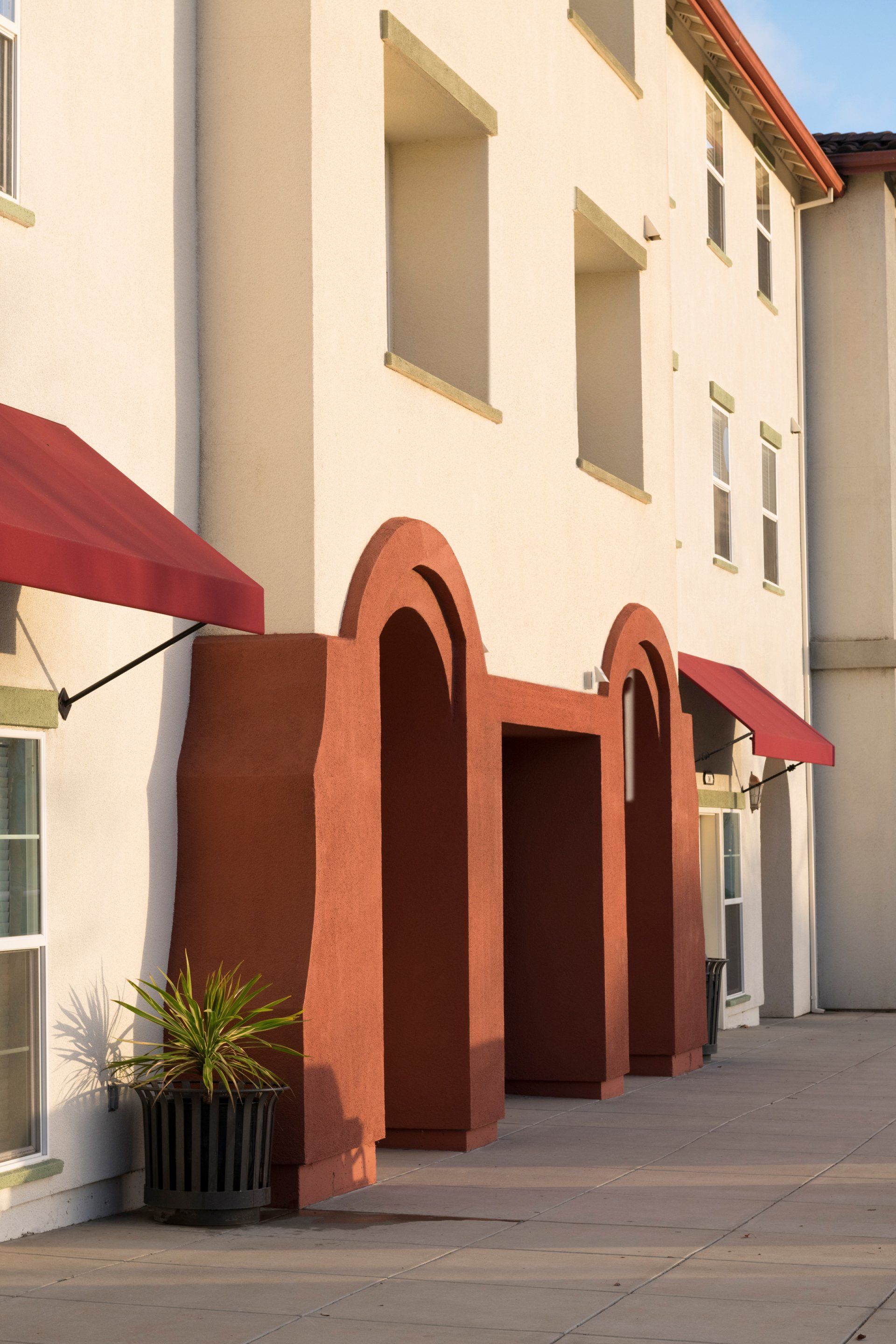 A building with red awnings on the windows