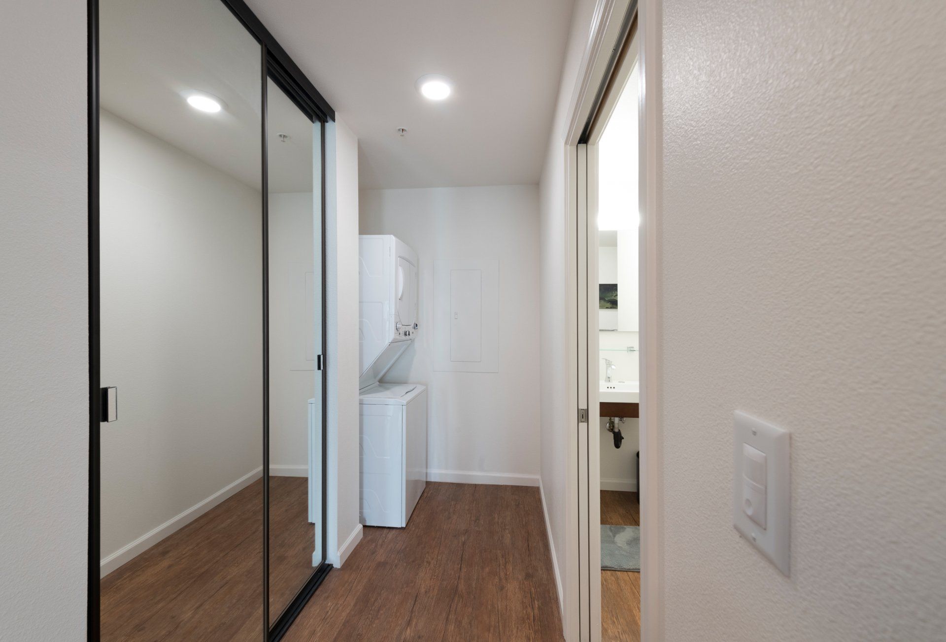 A hallway with a washer and dryer in it