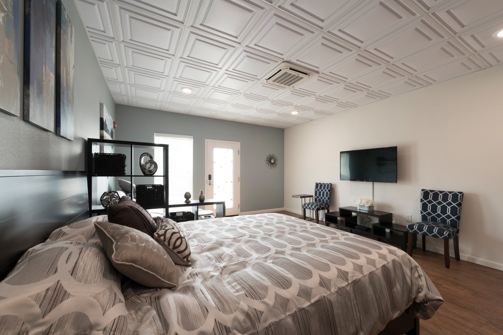 A bedroom with a bed and a flat screen tv