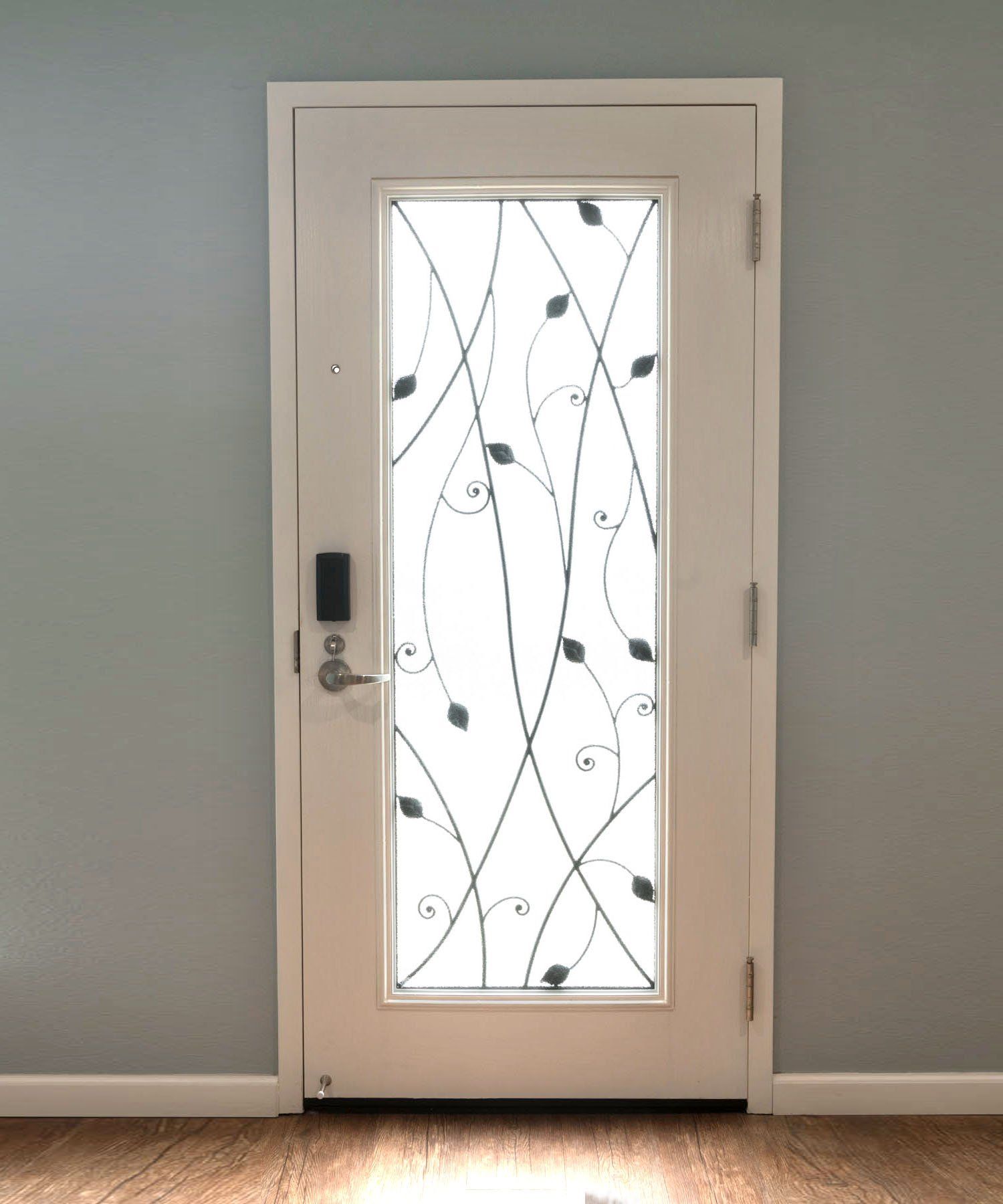 A white door with a wrought iron design on it