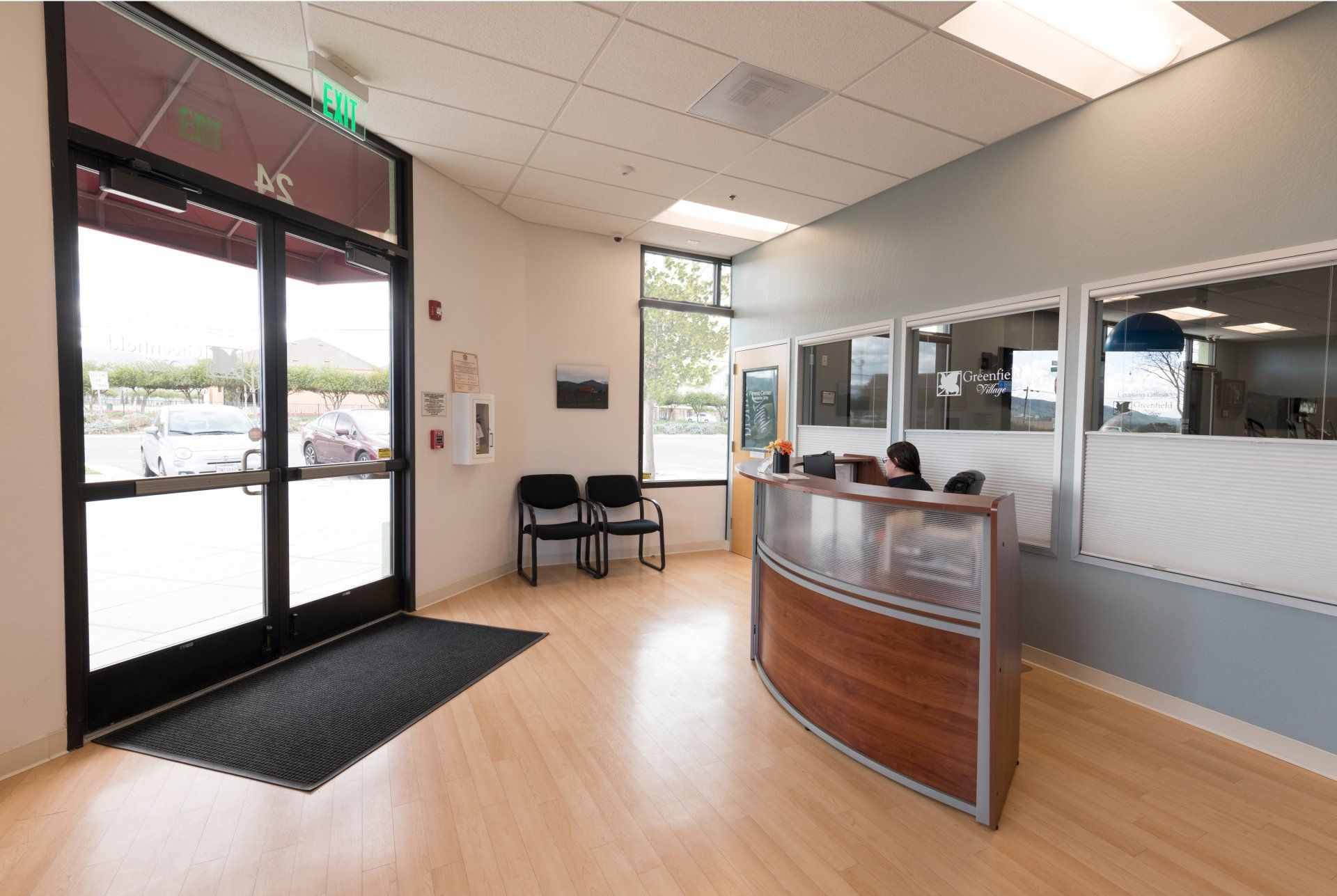 A reception area with a wooden desk and chairs