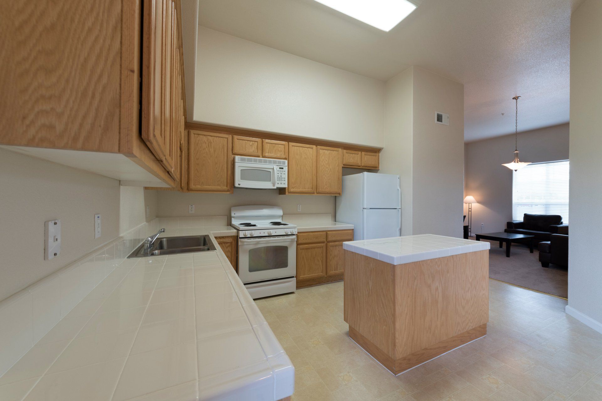 A kitchen with wooden cabinets and white appliances