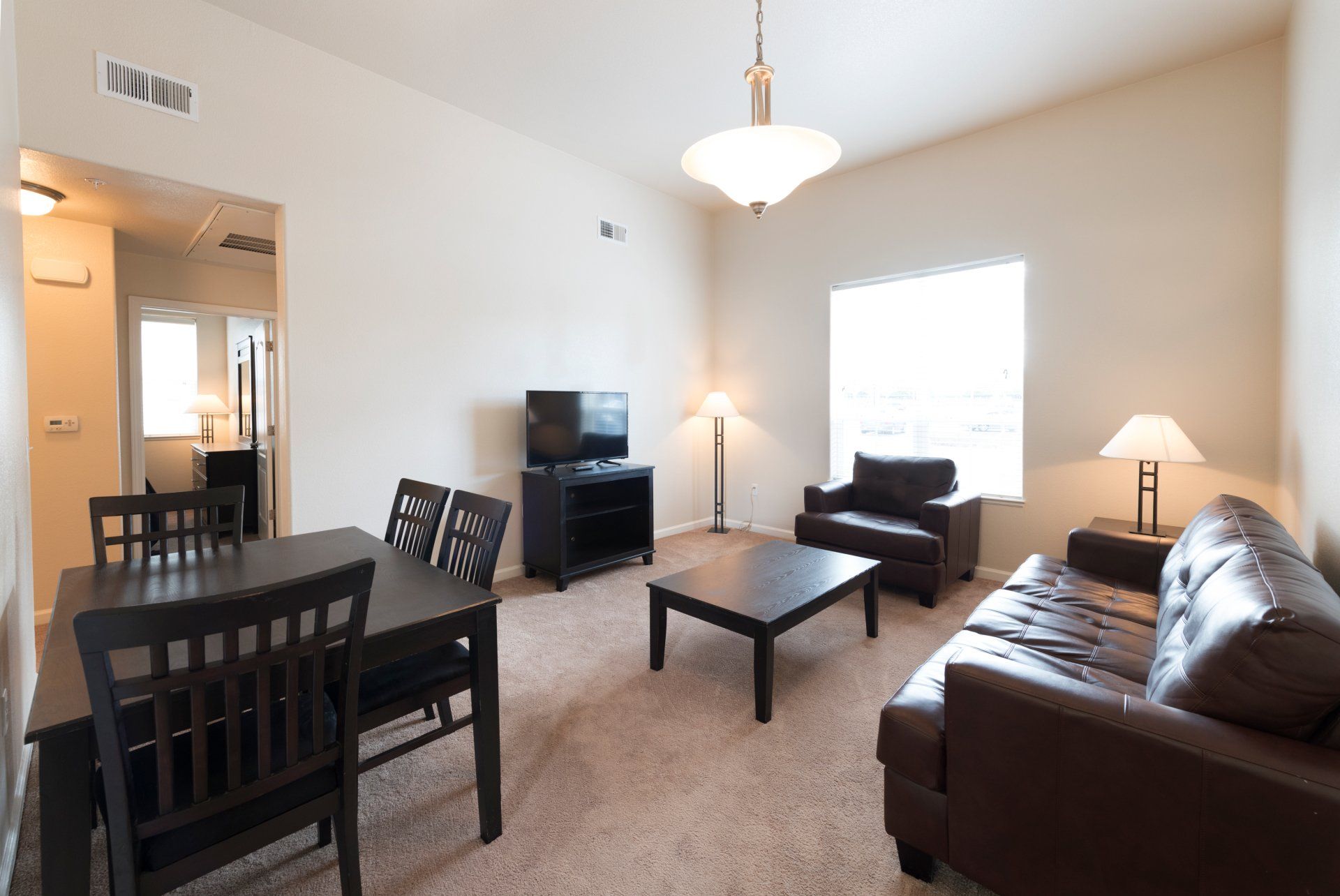 A living room with a couch a table and chairs