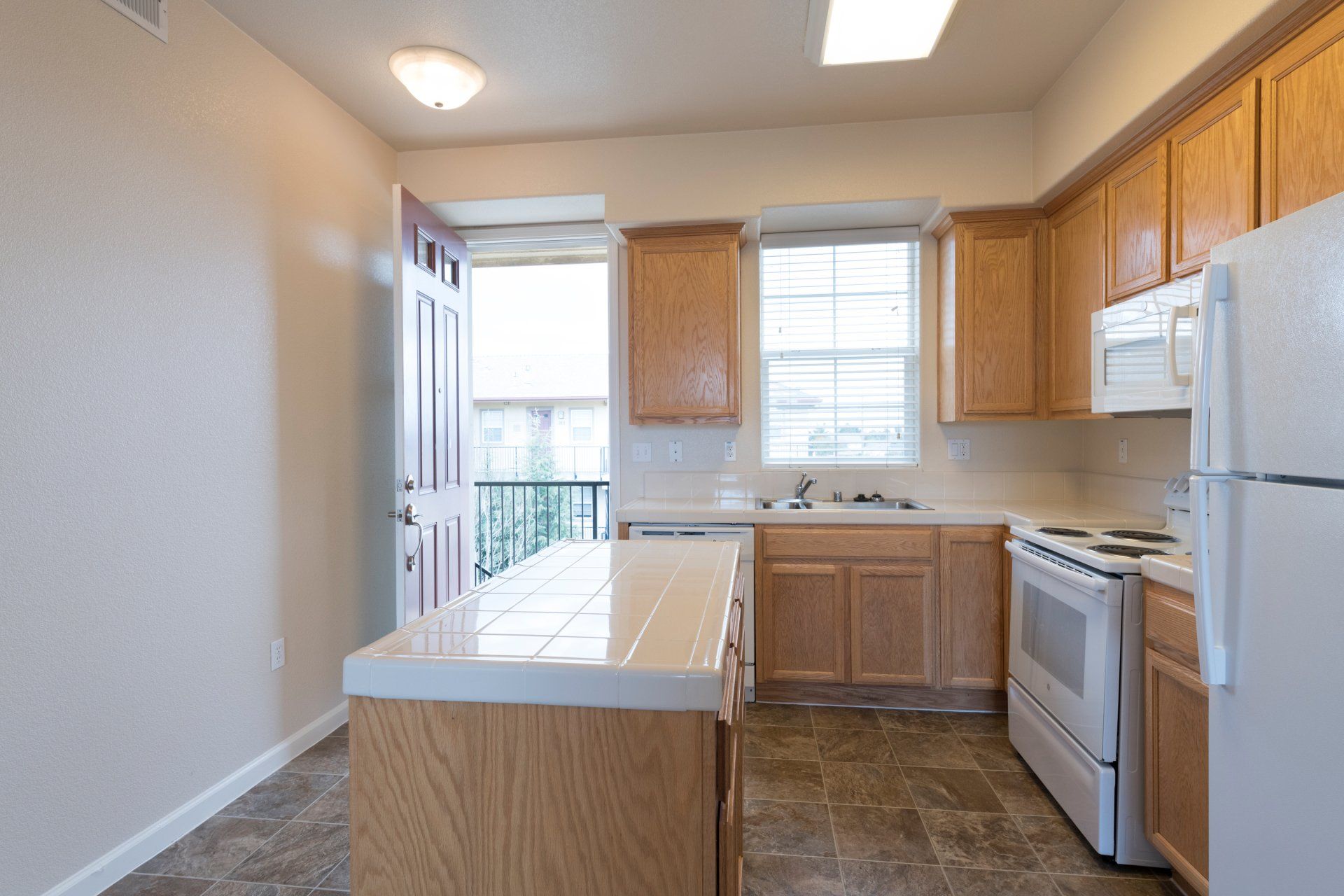 A kitchen with wooden cabinets and white appliances