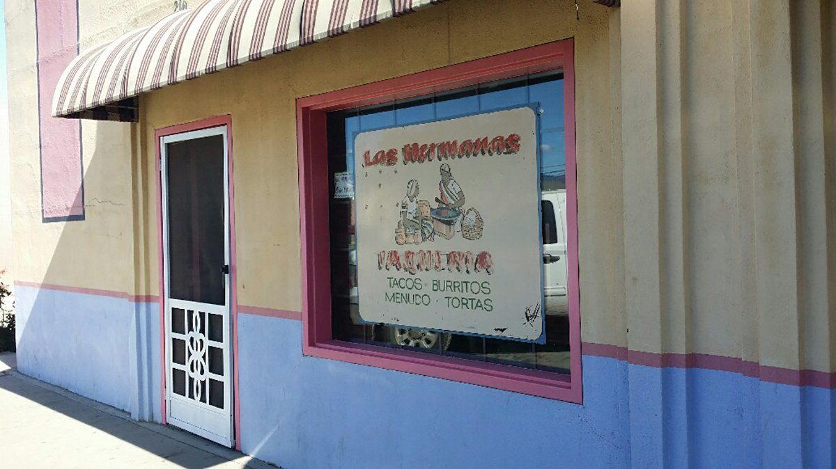 A mexican restaurant with a sign on the window