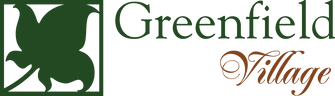 A green and white logo for greenfield village