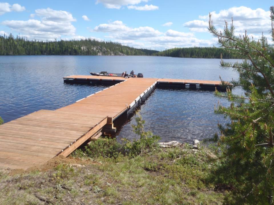 A dock on a lake with a boat on it