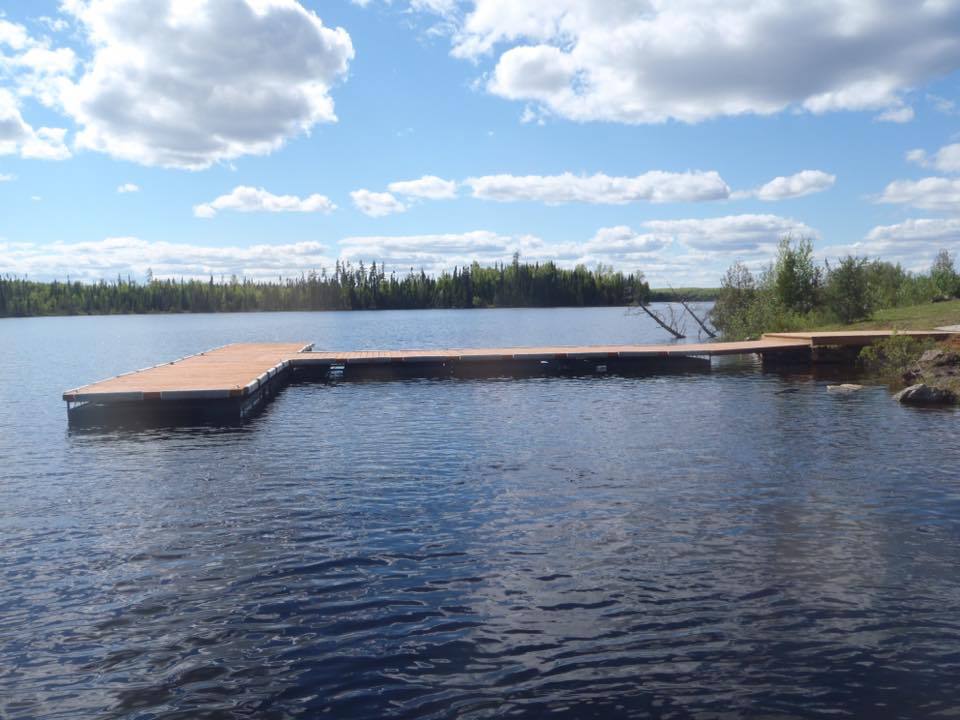 A large body of water with a dock in the middle of it