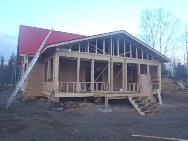 A house that is being built with a red roof