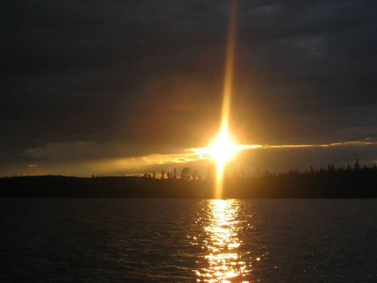 The sun is setting over a body of water