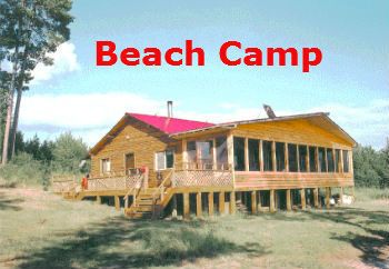 A large wooden house with a red roof is called the beach camp